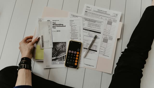 Financial documents and calculator being reviewed